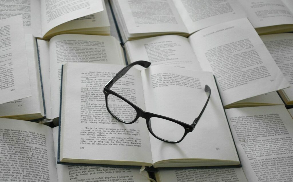 black framed eyeglasses on white book page